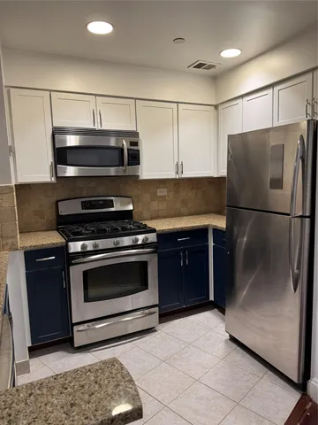 a kitchen with a refrigerator stove and microwave