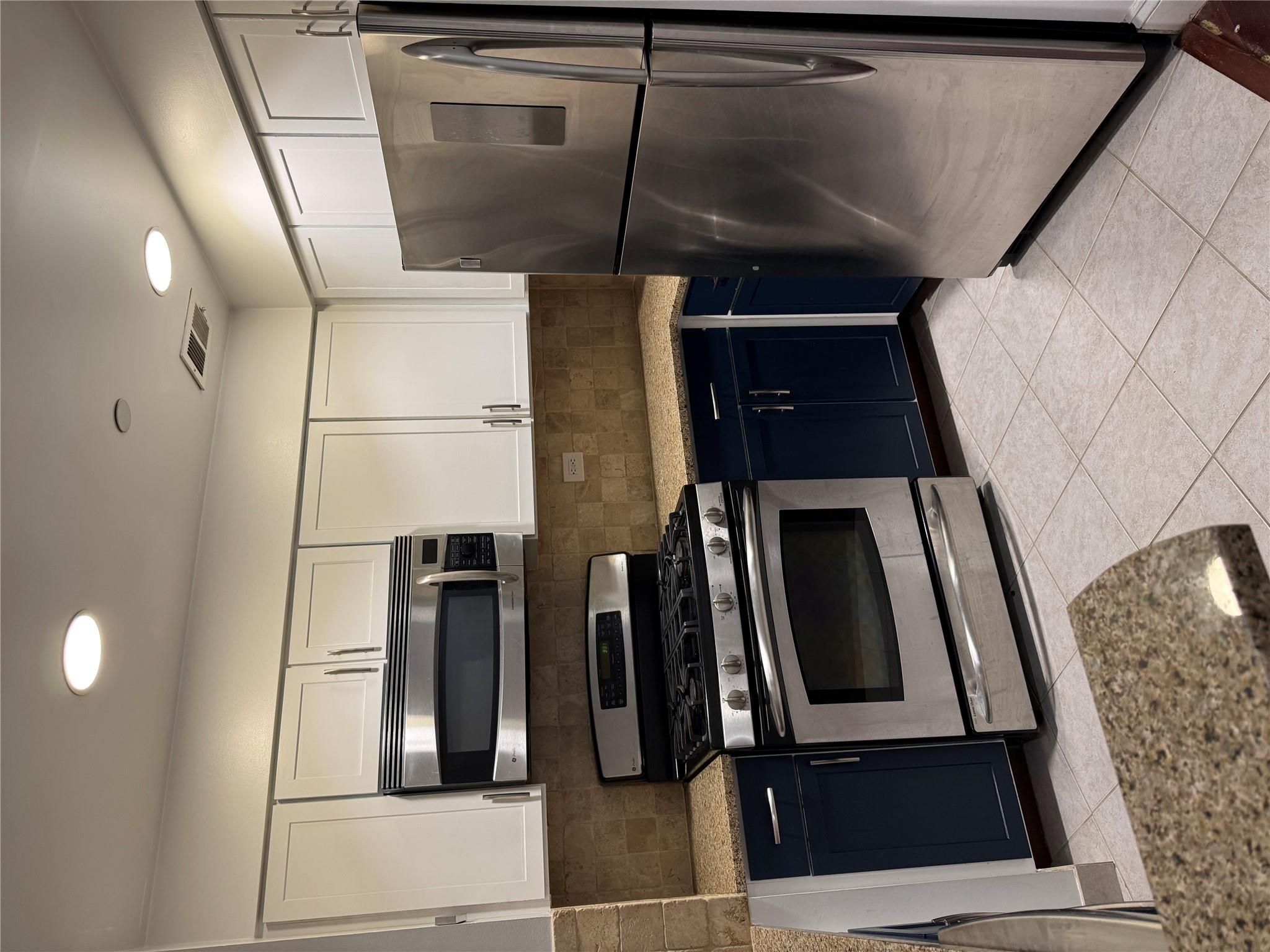 143-41 84th Drive, Unit 1A Queens, NY 11435 - Photo 2 of 7 a kitchen with a refrigerator stove and microwave