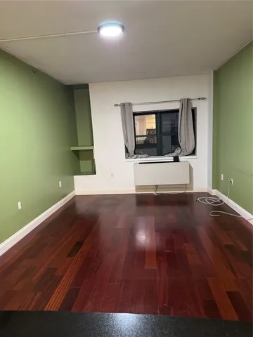 a view of a livingroom with wooden floor and a ceiling fan