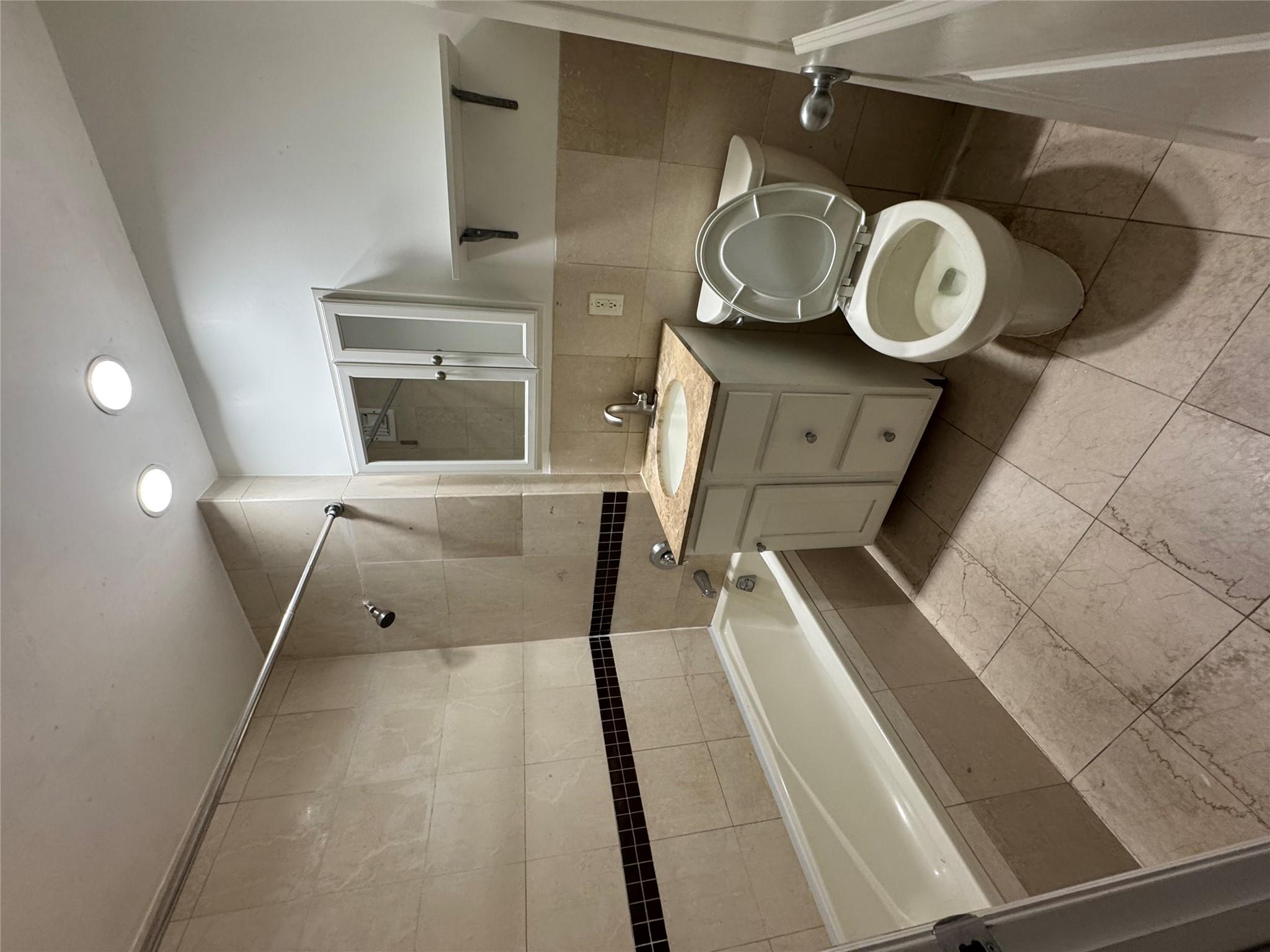 143-41 84th Drive, Unit 1A Queens, NY 11435 - Photo 5 of 7 a bathroom with a toilet sink and mirror