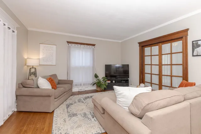 a view of a dining room with furniture wooden floor and next to a window
