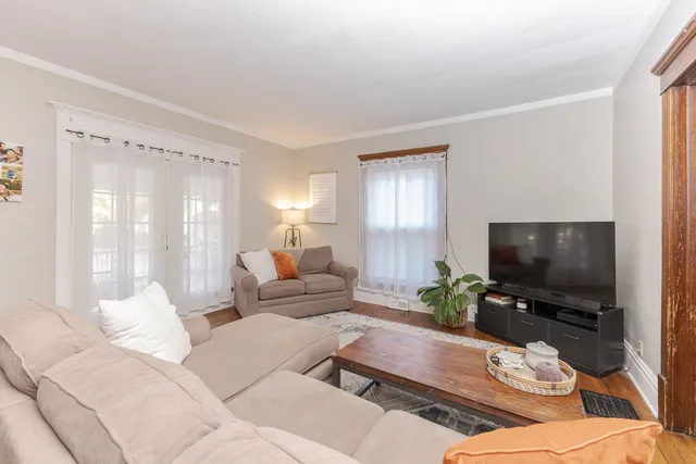 a living room with furniture and a chandelier