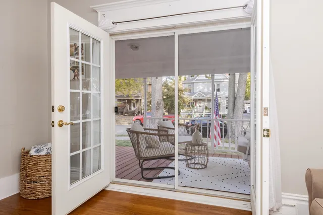 a dining room with furniture a rug a fireplace and a chandelier