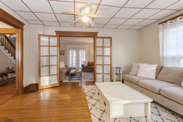 a kitchen with a dining table chairs and white appliances