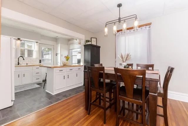a dining room with furniture and wooden floor