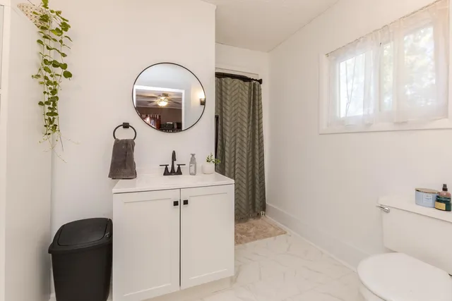 a bedroom with baby crib and hanging chair