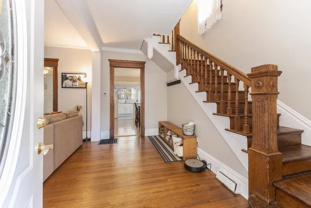 a view of an entryway with wooden floor and door
