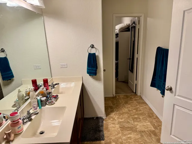 a bathroom with a tub sink and a mirror