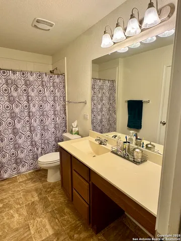 a bathroom with a double vanity sink mirror and toilet