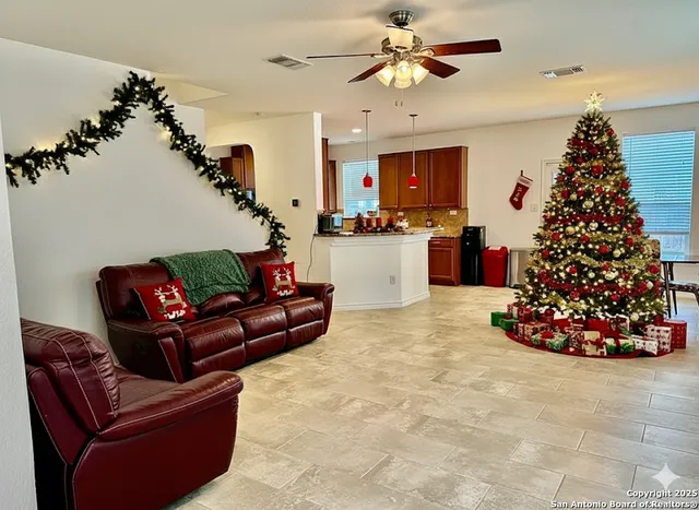 a living room with furniture and a christmas tree