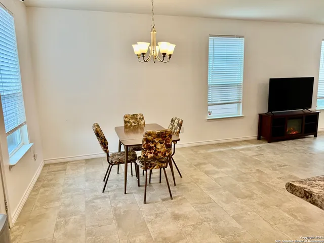 a dining room with furniture and window