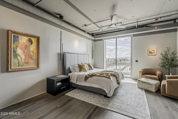 a spacious bedroom with a bed couch and a window