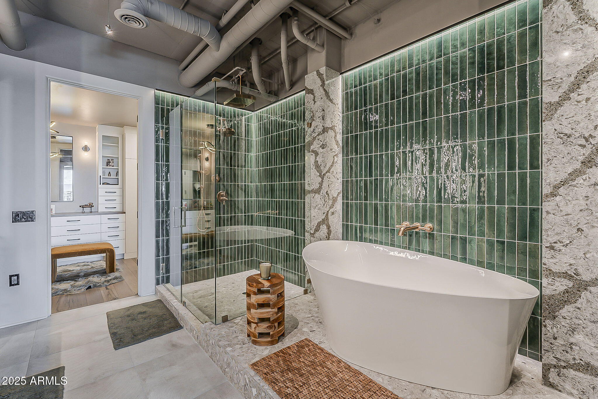 2211 East Camelback Road, Unit 605 Phoenix, AZ 85016 - Photo 15 of 23 a white bath tub sitting next to a bathroom