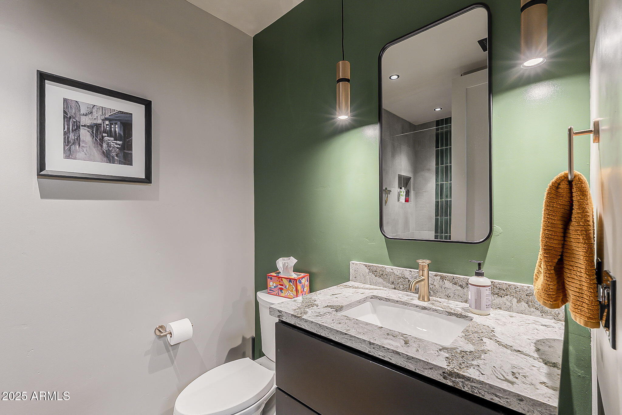 2211 East Camelback Road, Unit 605 Phoenix, AZ 85016 - Photo 17 of 23 a bathroom with a granite countertop sink mirror vanity and toilet