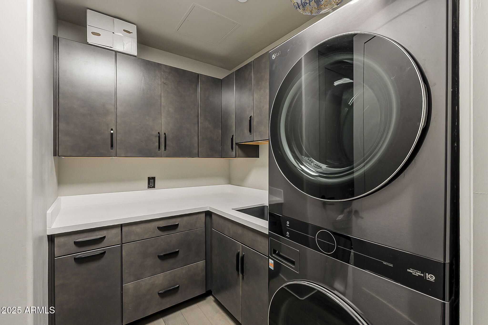 2211 East Camelback Road, Unit 605 Phoenix, AZ 85016 - Photo 19 of 23 a utility room with cabinets dryer and washer