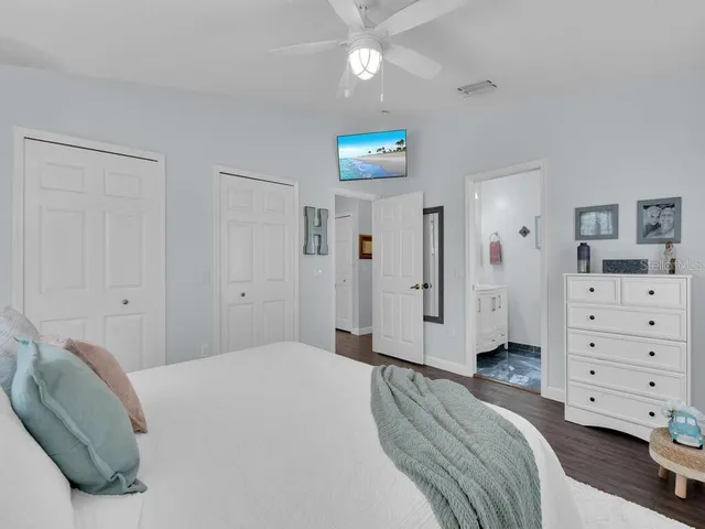 a bedroom with a bed and ceiling fan