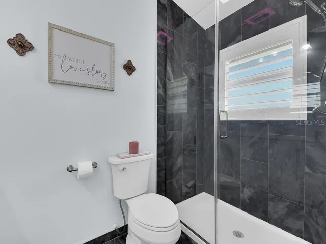 a white toilet sitting next to a bathroom sink