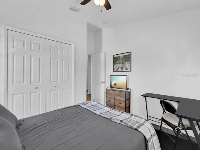a bedroom with a bed and a chandelier