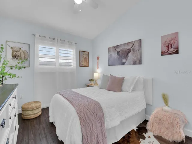 a bedroom with a bed and a painting on the wall