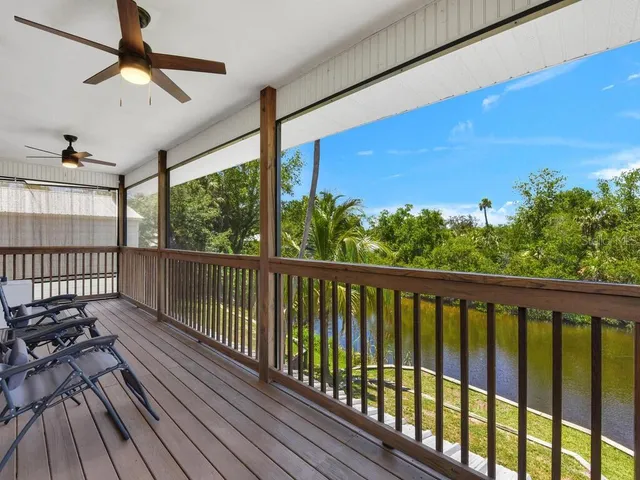 a balcony with wooden floor and city view