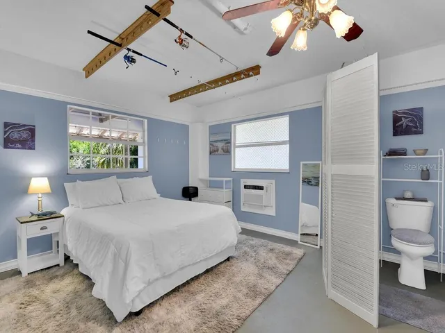 a bedroom with a bed and a chandelier