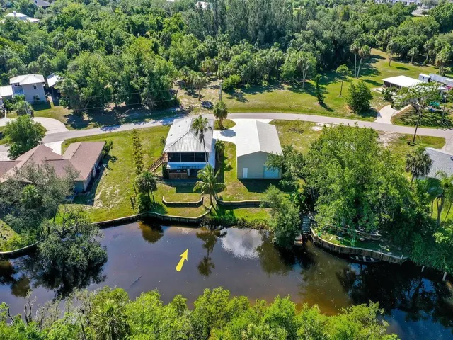 an aerial view of a house with swimming pool outdoor seating and yard