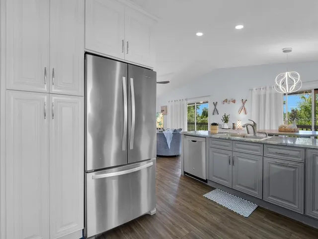 a kitchen with stainless steel appliances a refrigerator and a sink