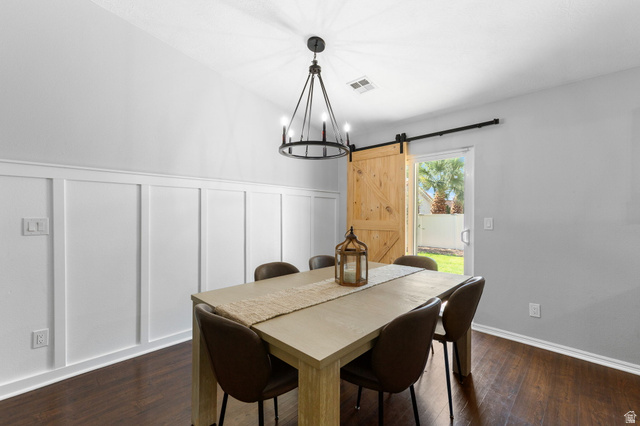 664 East Springhill Drive Washington, UT 84780 - Photo 8 of 21 Dining area featuring board and batten wainscoting, wood-finish flooring, and a modern black chandelier