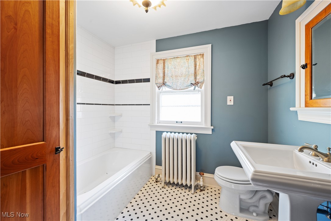 24510 Lake Road Bay Village, OH 44140 - Photo 42 of 45 Full bathroom with radiator heating unit, bathing tub / shower combination, and tile patterned flooring