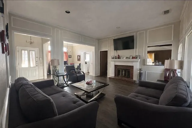 a living room with furniture fireplace and flat screen tv