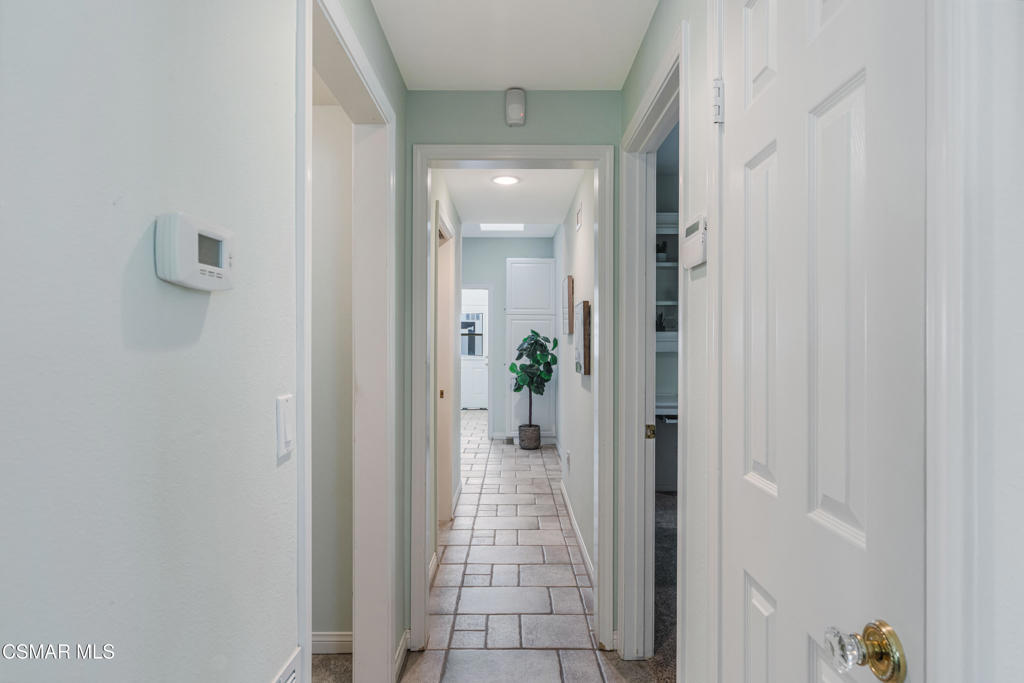637 Bluegrass Street Simi Valley, CA 93065 - Photo 28 of 67 a view of a hallway with wooden shelves