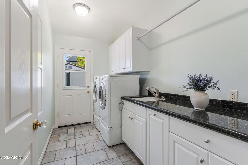 637 Bluegrass Street Simi Valley, CA 93065 - Photo 37 of 67 a kitchen with sink and refrigerator
