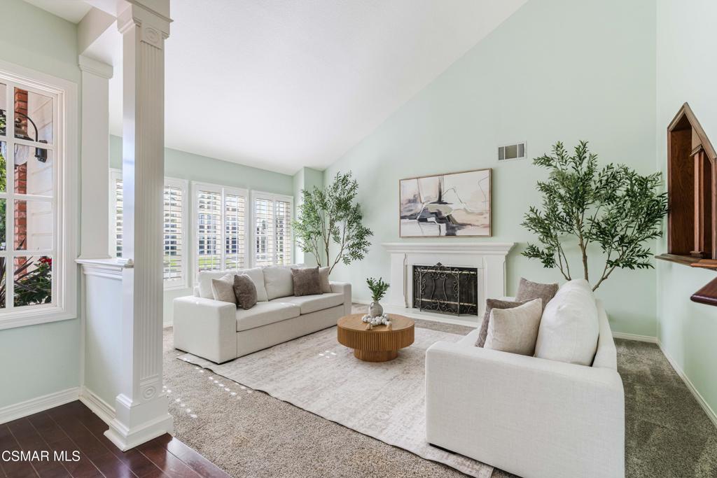 637 Bluegrass Street Simi Valley, CA 93065 - Photo 9 of 67 a living room with furniture a potted plant and a fireplace