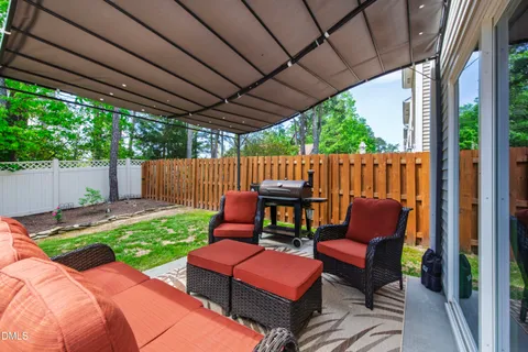 a view of a house with backyard and sitting area