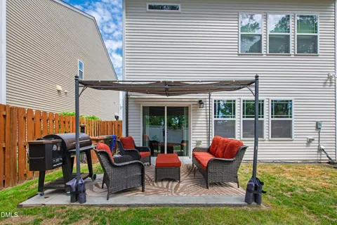 a view of a backyard with wooden fence