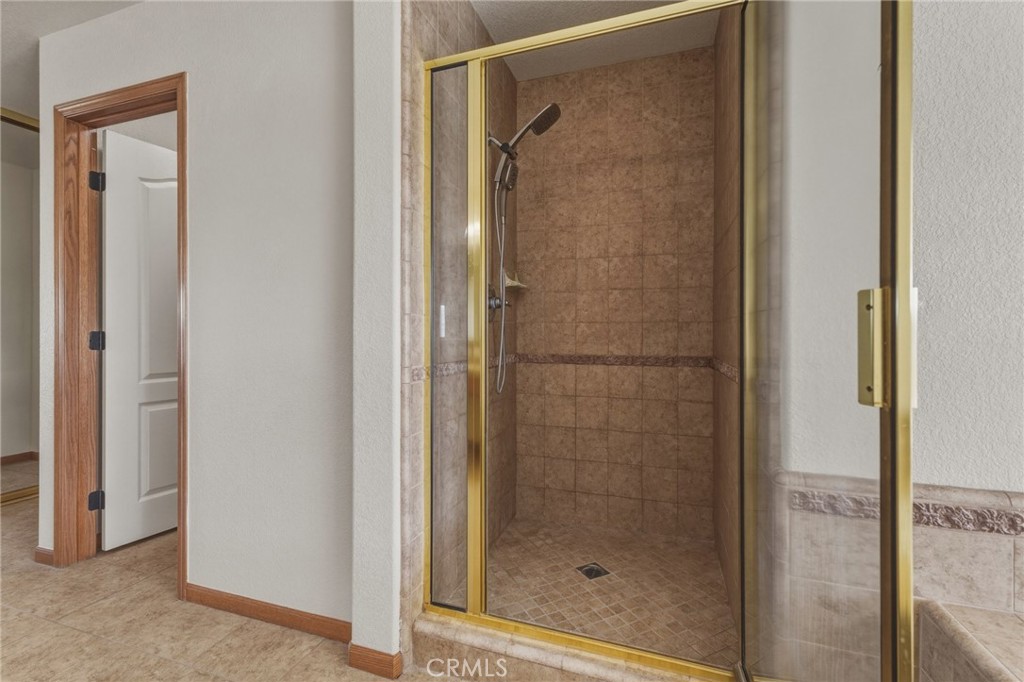 19501 Kinai Road Apple Valley, CA 92307 - Photo 30 of 49 a bathroom with a glass shower door
