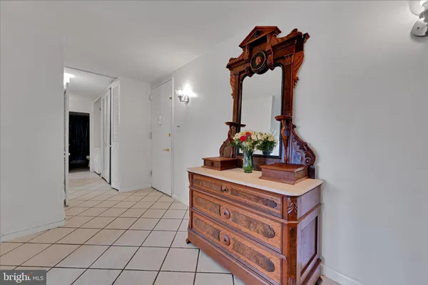 a view of hallway with a mirror and a sink