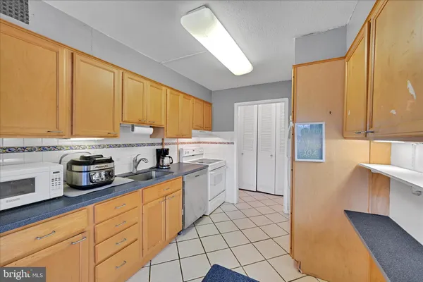 a kitchen with stainless steel appliances a refrigerator sink and cabinets