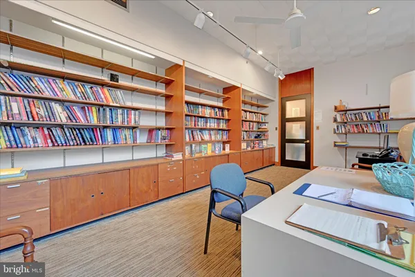 a room with a book shelf and wooden floor