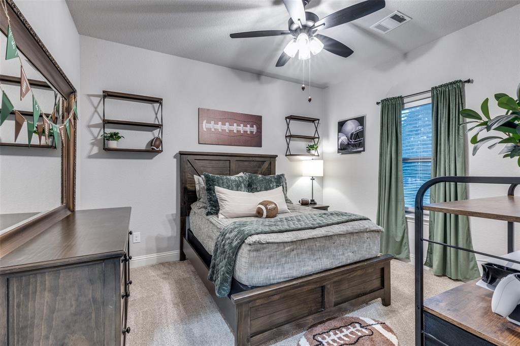 109 Highland Ranch Drive Paradise, TX 76073 - Photo 18 of 33 a bedroom with a bed a desk and painting on the wall