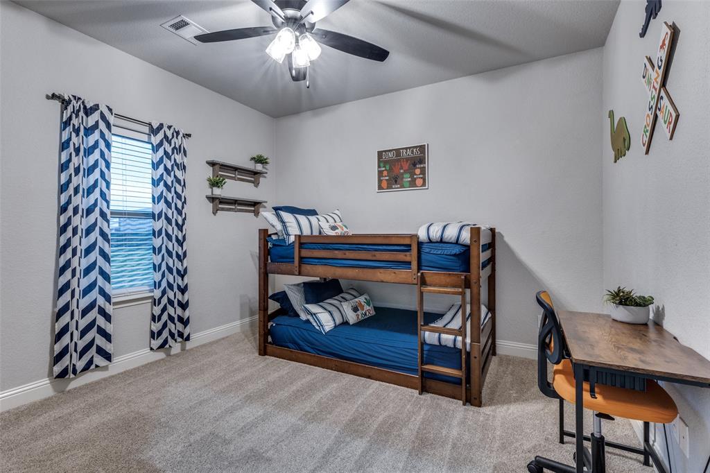 109 Highland Ranch Drive Paradise, TX 76073 - Photo 19 of 33 a bedroom with furniture and a chandelier