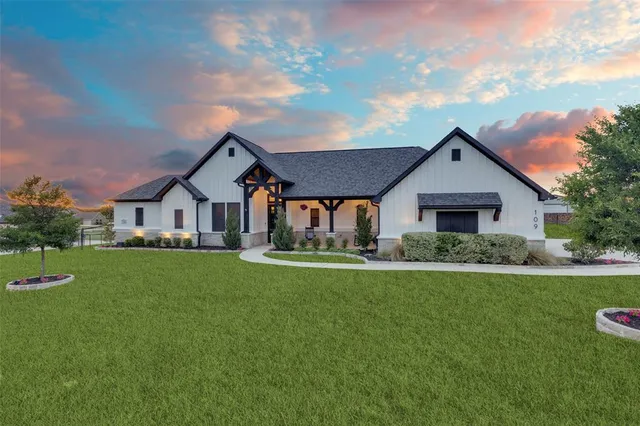 a front view of house with yard and green space