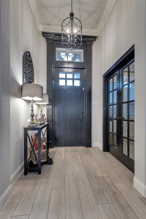 109 Highland Ranch Drive Paradise, TX 76073 - Photo 4 of 33 a view of an empty room with wooden floor and a chandelier