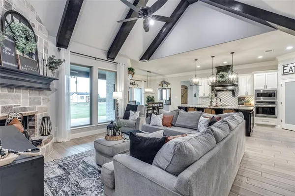 a living room with furniture wooden floor and a fireplace