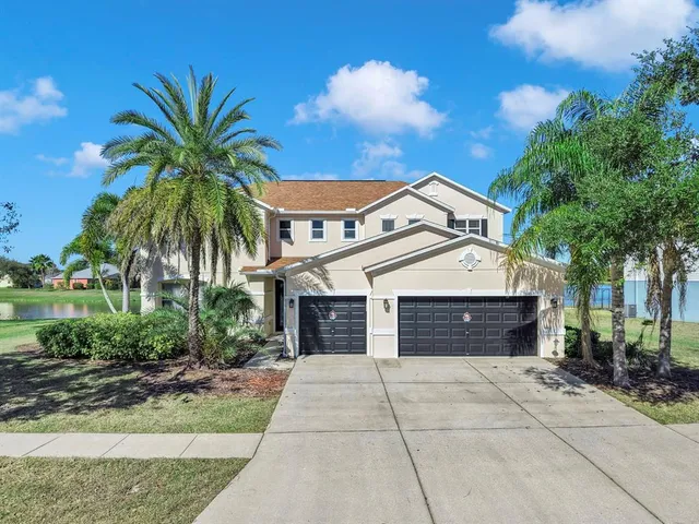 a front view of a house with a yard and garage