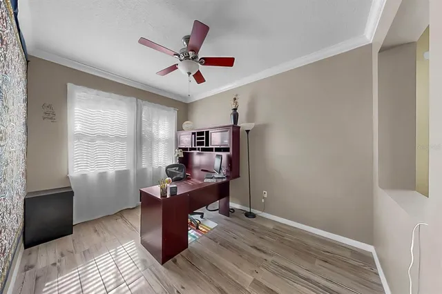 a spacious bedroom with a bed and a chandelier