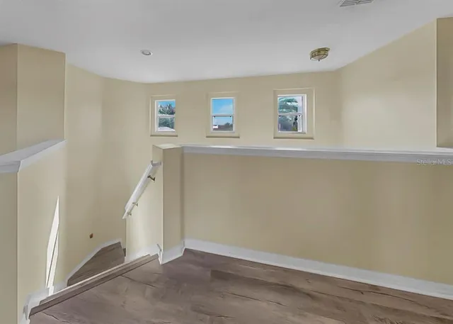 an aerial view of a house with outdoor space and lake view in back