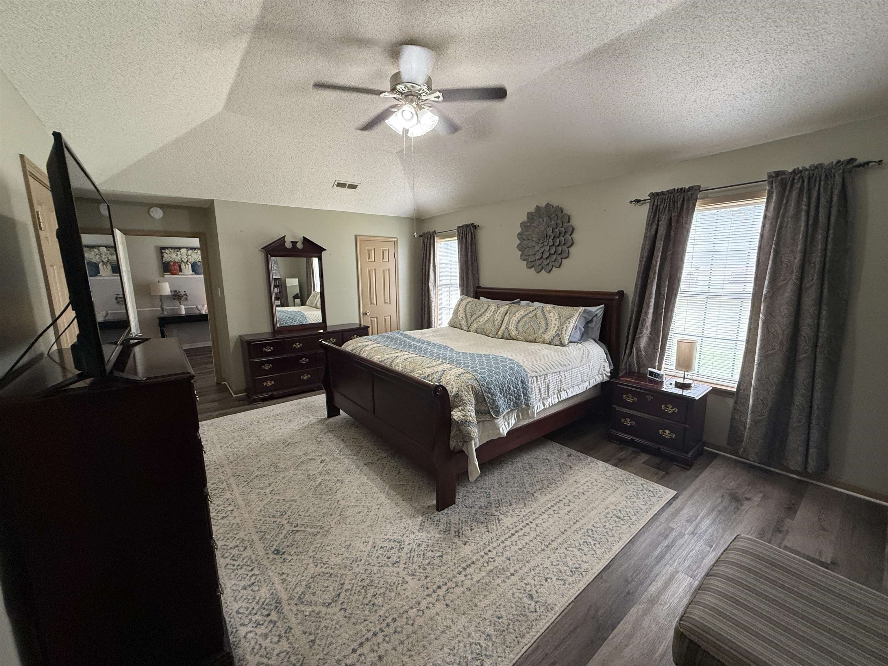 185 Mignon Road Atoka, TN 38004 - Photo 21 of 34 Vaulted ceiling with a ceiling fan, dual windows, and wood-finish flooring