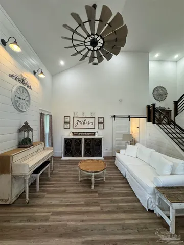 a living room with furniture and a wooden floor