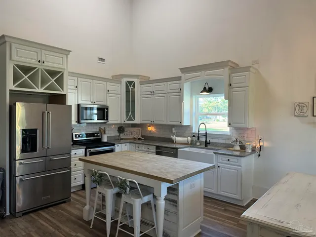 a kitchen with a table chairs and refrigerator